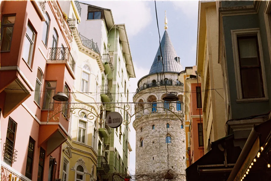 View of Galata Tower surrounded by colorful buildings in Istanbul.